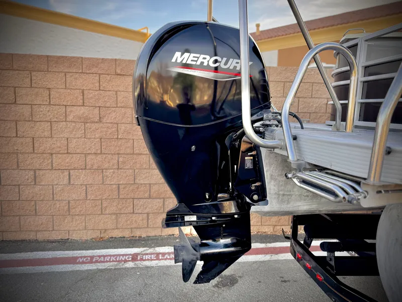 Slide: The Image of 2021 Bennington 23 LPD with Mercury outboard motor, parked near brick wall. - 7