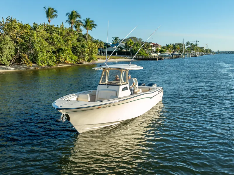 Slide: The Image of 2017 Grady-White Canyon 306 boat cruising on a sunny, tropical waterway. - 18