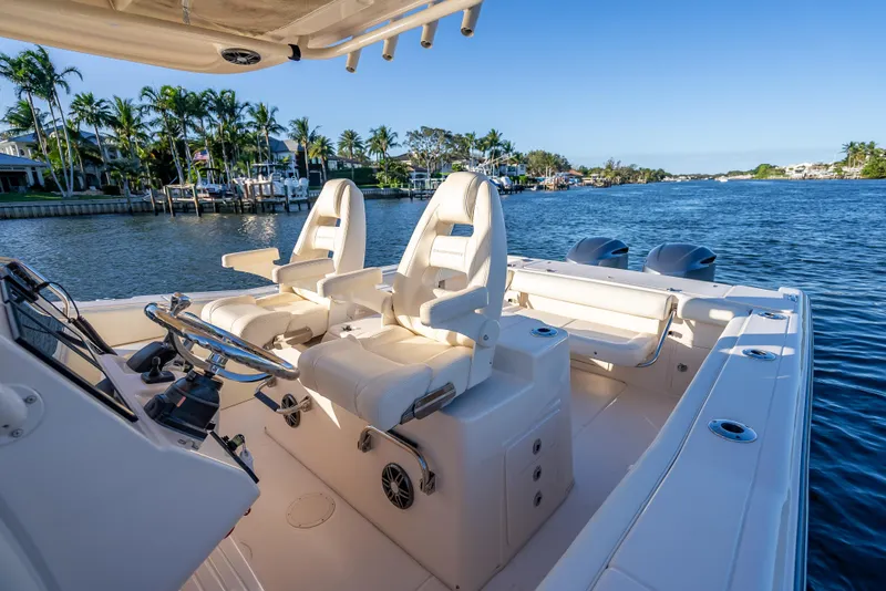 Slide: The Image of 2017 Grady-White Canyon 306 boat interior with dual seats on a scenic waterway. - 40