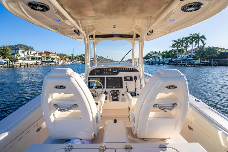 Slide: The Image of 2017 Grady-White Canyon 306 boat interior with dual seats, steering, and waterfront view. - 48