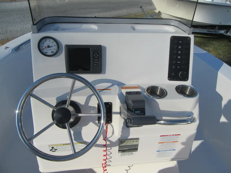 Slide: The Image of 2016 Robalo R160 Center Console dashboard with steering wheel and controls. - 13