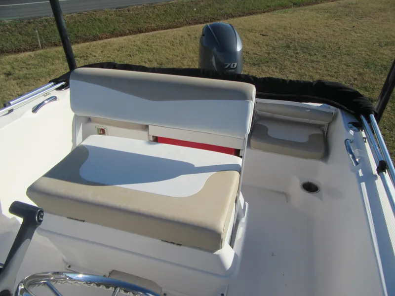 Slide: The Image of 2016 Robalo R160 Center Console boat interior with seating and motor. - 14
