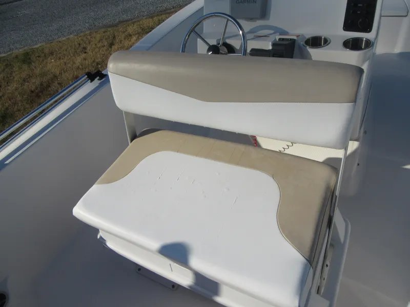 Slide: The Image of 2016 Robalo R160 Center Console boat seat and steering area. - 16