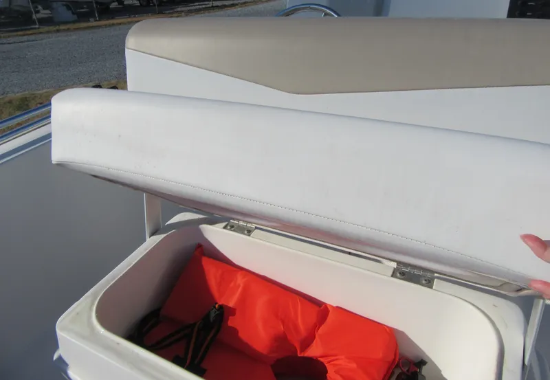 Slide: The Image of 2016 Robalo R160 Center Console boat seat storage with life jacket. - 17