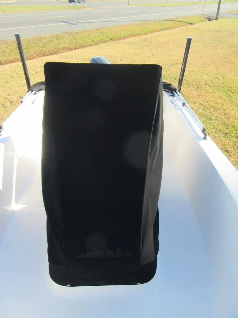 Slide: The Image of 2016 Robalo R160 Center Console boat with black cover, parked on grass. - 9