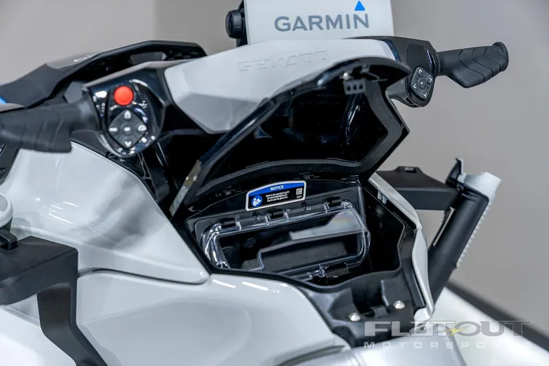 Slide: The Image of 2024 Sea-Doo Fish Pro 130 Scout with Garmin display, showcasing storage compartment. - 18