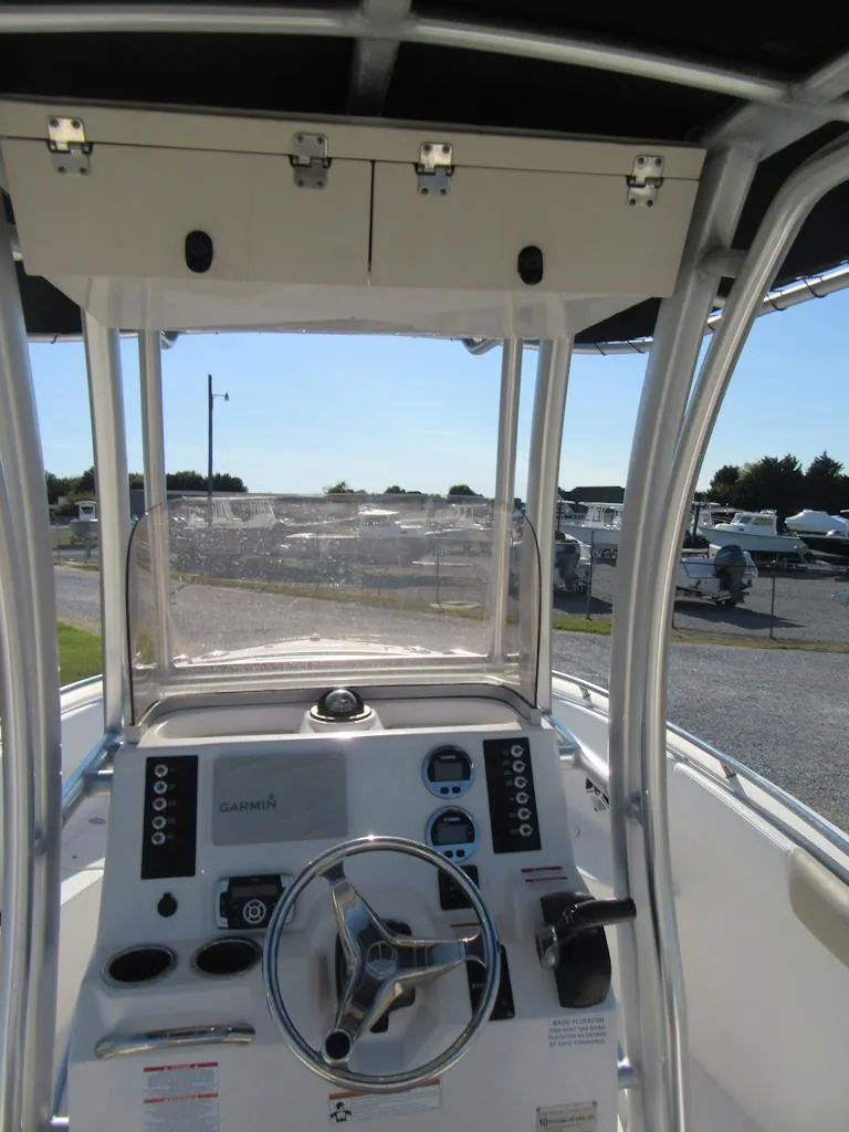 Slide: The Image of 2018 Robalo R222 Center Console boat dashboard with steering wheel and controls. - 11