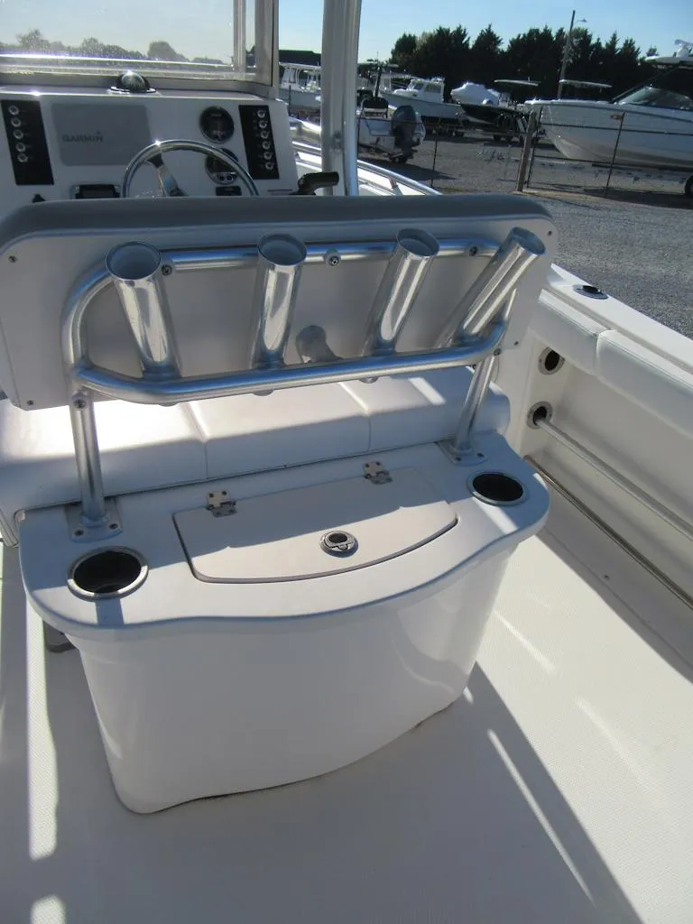 Slide: The Image of 2018 Robalo R222 Center Console boat interior with rod holders and storage. - 14
