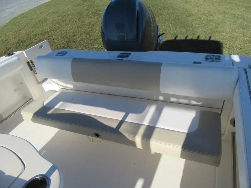 Slide: The Image of 2018 Robalo R222 Center Console boat seating area with engine view. - 18