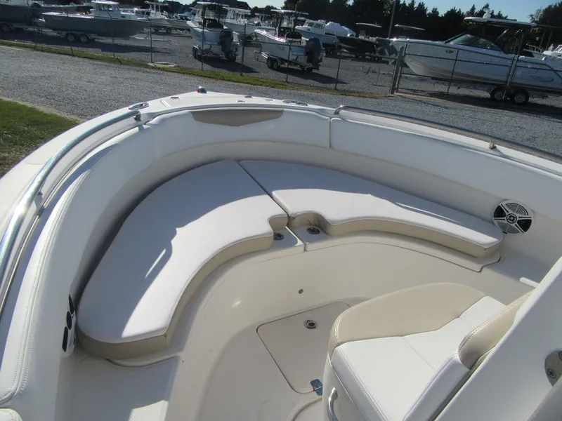 Slide: The Image of 2018 Robalo R222 Center Console boat with cushioned seating area. - 5