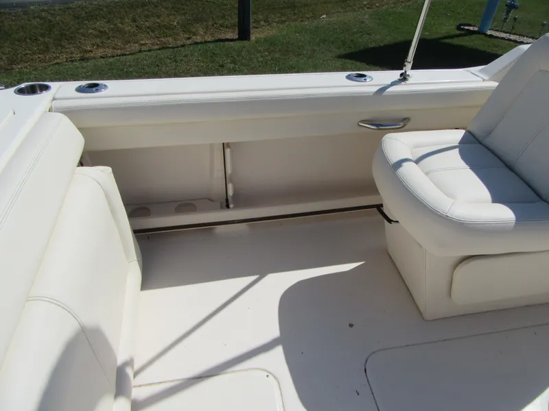Slide: The Image of 2017 Grady-White 225 Freedom boat interior with white seating and cup holders. - 12