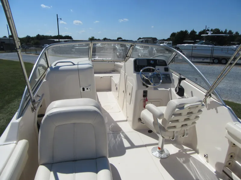 Slide: The Image of 2017 Grady-White 225 Freedom boat interior with white seating and steering console. - 15