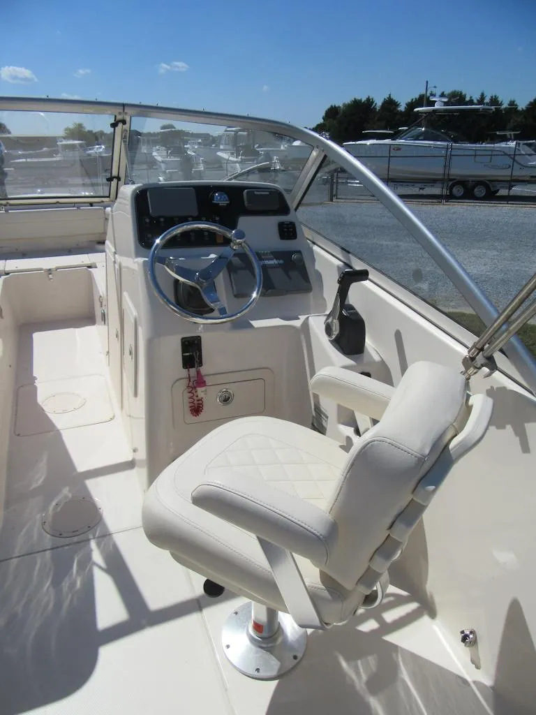 Slide: The Image of 2017 Grady-White 225 Freedom boat interior with steering wheel and captain's chair. - 16