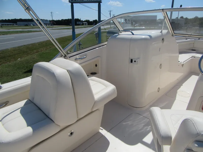 Slide: The Image of 2017 Grady-White 225 Freedom boat interior with white seating and dashboard. - 17