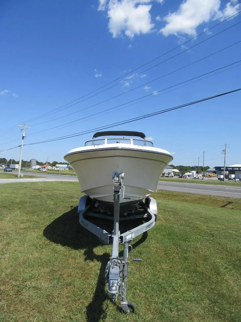 Slide: The Image of 2017 Grady-White 225 Freedom boat on trailer under clear blue sky. - 2