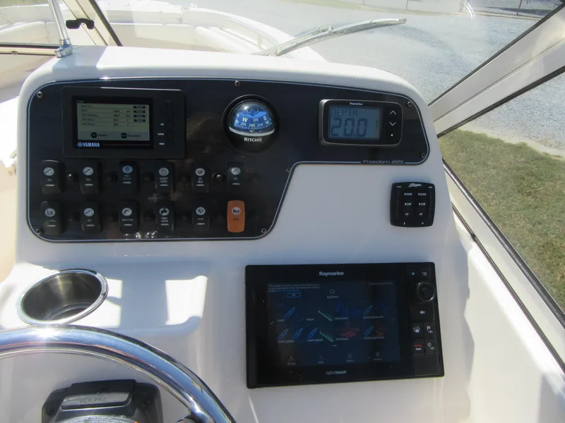 Slide: The Image of 2017 Grady-White 225 Freedom boat dashboard with navigation and control panels. - 20