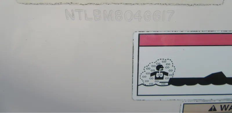 Slide: The Image of Grady-White 225 Freedom 2017 boat with hull identification number and warning label. - 5