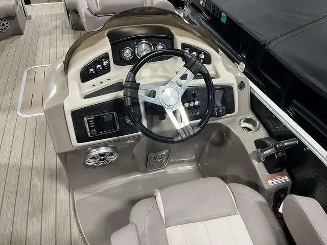 Slide: The Image of 2018 Bennington 25GSB boat dashboard with steering wheel and control panel. - 10