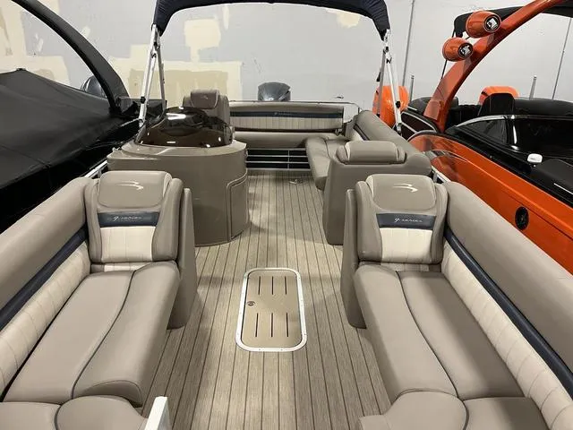 Slide: The Image of 2018 Bennington 25GSB pontoon boat interior with beige seating and wood-style flooring. - 11
