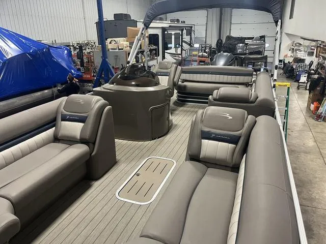 Slide: The Image of 2018 Bennington 25GSB pontoon boat interior with luxurious seating in a workshop setting. - 12