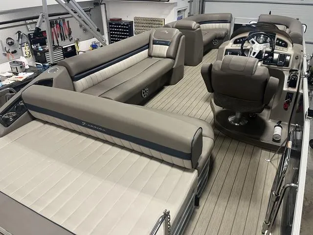 Slide: The Image of Interior of a 2018 Bennington 25GSB pontoon boat with luxurious seating and helm. - 7