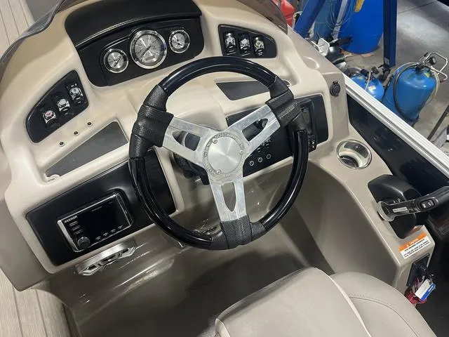 Slide: The Image of 2018 Bennington 25GSB boat dashboard with steering wheel and control panel. - 9