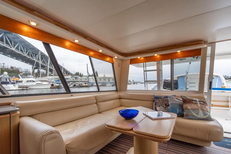 Slide: The Image of Luxurious interior of 2000 Bayliner 4788 Pilot House Motoryacht with waterfront view. - 12