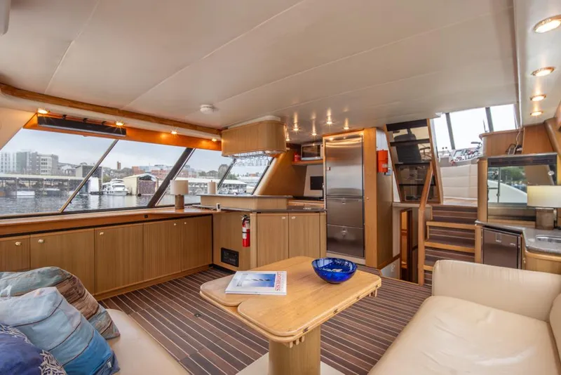 Slide: The Image of Luxurious interior of 2000 Bayliner 4788 Pilot House Motoryacht with modern kitchen and seating. - 16