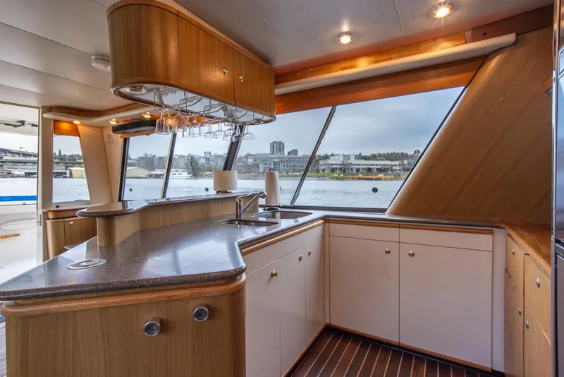 Slide: The Image of Luxurious kitchen interior of 2000 Bayliner 4788 Pilot House Motoryacht with waterfront view. - 19