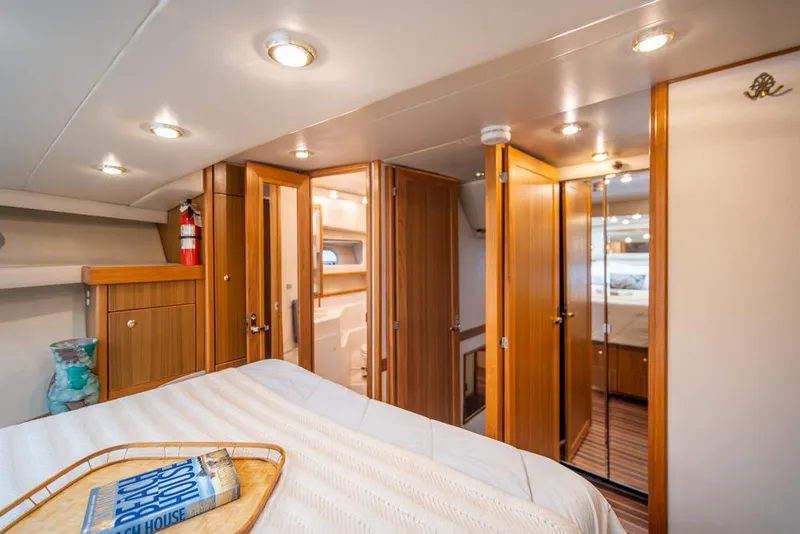 Slide: The Image of Luxurious interior of 2000 Bayliner 4788 Pilot House Motoryacht with wood accents and cozy lighting. - 25