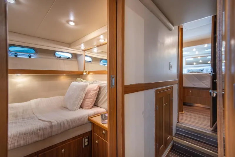 Slide: The Image of Cozy cabin interior of 2000 Bayliner 4788 Pilot House Motoryacht with wood accents and bedding. - 30