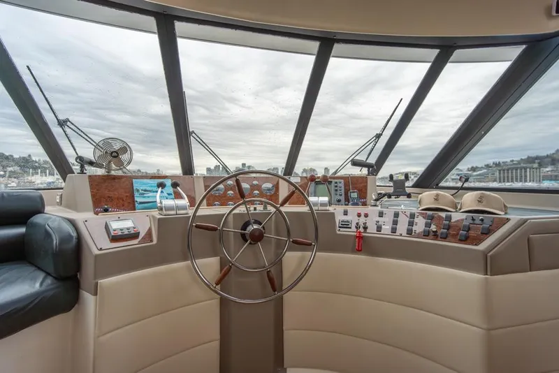 Slide: The Image of Bayliner 4788 Pilot House Motoryacht 2000 helm with panoramic windows and control panel. - 38