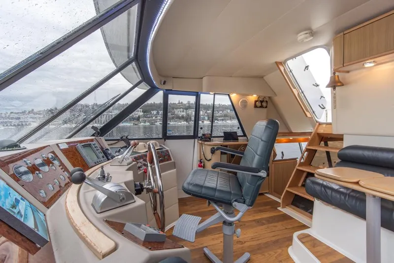 Slide: The Image of 2000 Bayliner 4788 Pilot House Motoryacht interior with helm, seating, and panoramic windows. - 41