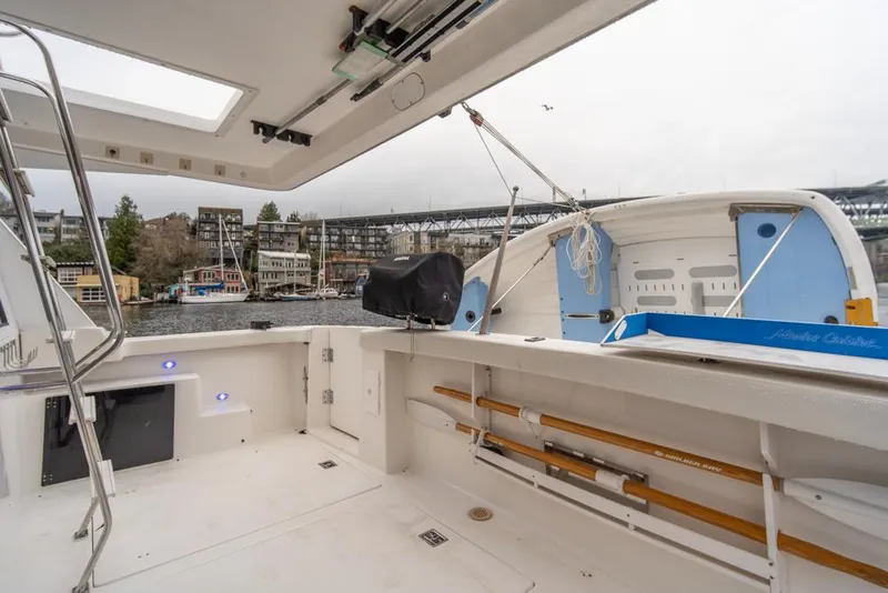 Slide: The Image of Bayliner 4788 Pilot House Motoryacht 2000, spacious deck view, docked near waterfront homes. - 43