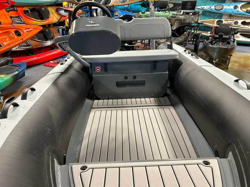 Slide: The Image of 2025 Highfield Classic 400 inflatable boat interior with steering console and seating. - 2