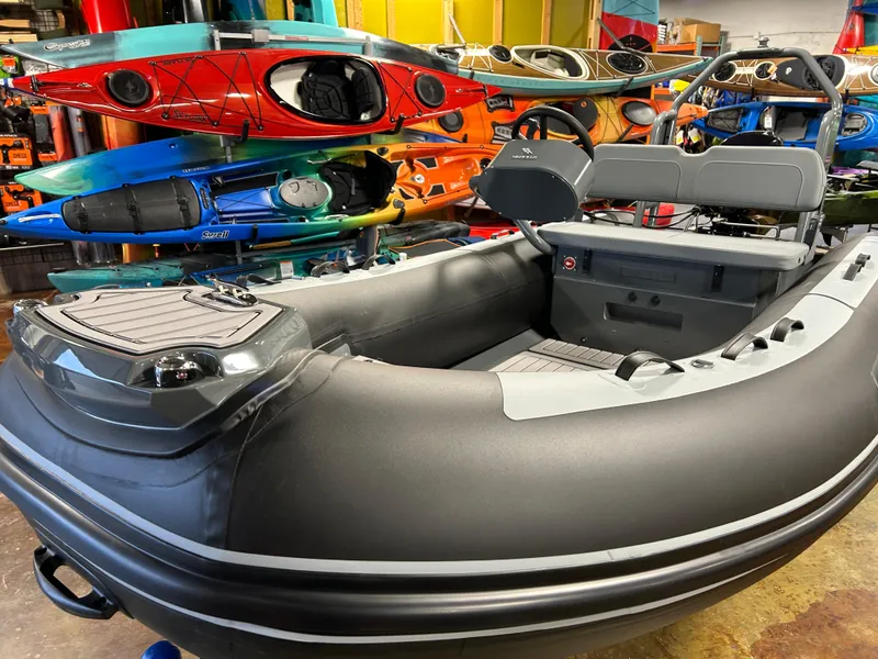 Slide: The Image of 2025 Highfield Classic 400 inflatable boat in showroom with colorful kayaks. - 3