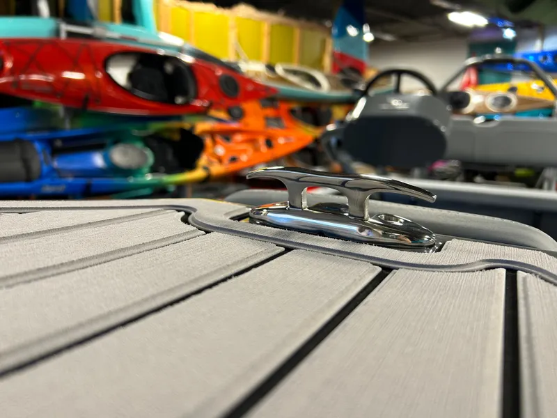 Slide: The Image of Highfield Classic 400 boat detail with colorful kayaks in the background, 2025 model. - 8