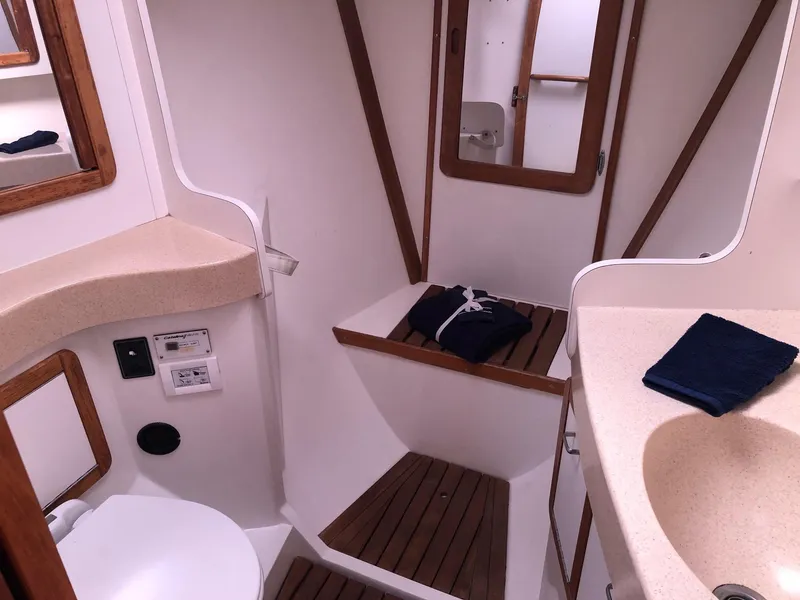 Slide: The Image of Interior of 1996 Catalina 42 MkII sailboat bathroom with sink, toilet, and mirror. - 13