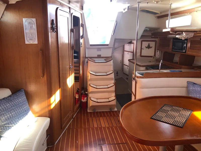 Slide: The Image of Interior of a 1996 Catalina 42 MkII sailboat with wooden finishes and cozy seating. - 15