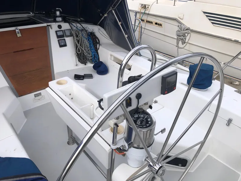 Slide: The Image of 1996 Catalina 42 MkII sailboat cockpit with steering wheel and navigation instruments. - 24
