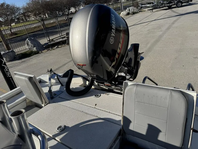 Slide: The Image of Avid FS 2021 boat with Yamaha outboard motor in a parking area. - 7