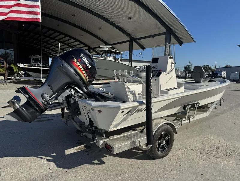 Slide: The Image of 2021 Avid FS boat with Yamaha motor on trailer, parked outdoors. - 9