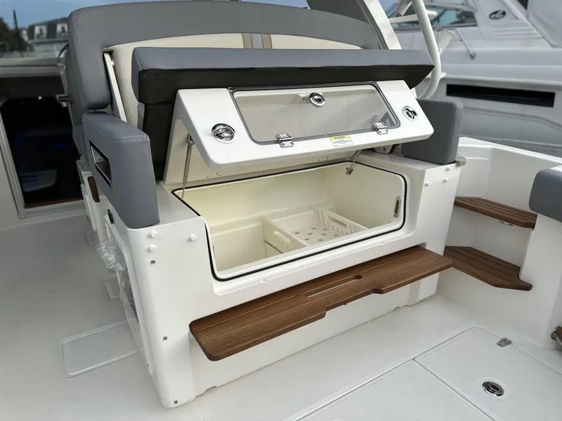 Slide: The Image of 2025 Boston Whaler 380 Realm boat interior with storage compartment and seating. - 10