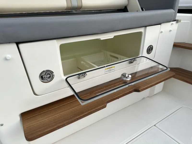 Slide: The Image of Open storage compartment on 2025 Boston Whaler 380 Realm boat interior. - 11