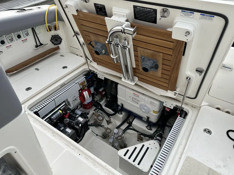 Slide: The Image of 2025 Boston Whaler 380 Realm engine compartment with equipment and storage features. - 12
