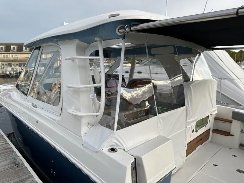 Slide: The Image of 2025 Boston Whaler 380 Realm docked, showcasing sleek design and modern features. - 16