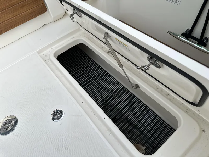 Slide: The Image of Open storage compartment on 2025 Boston Whaler 380 Realm boat deck. - 17