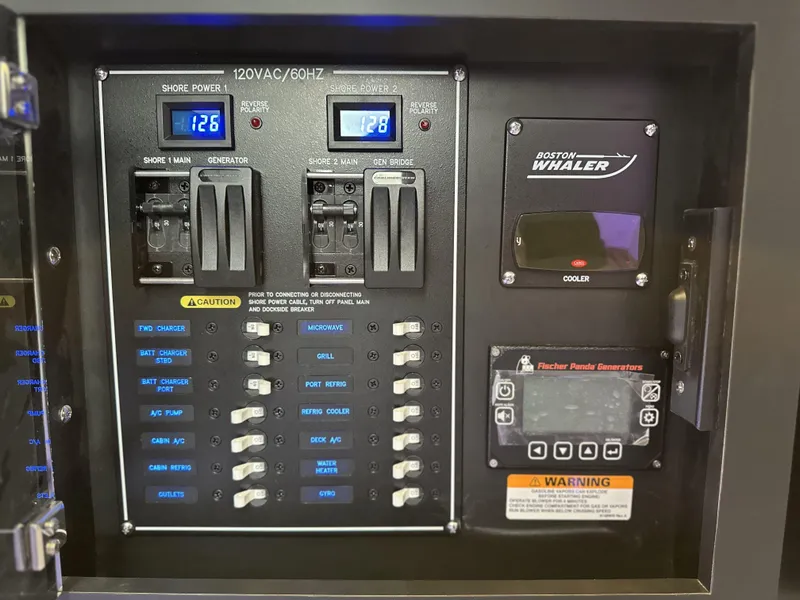 Slide: The Image of Electrical panel of 2025 Boston Whaler 380 Realm boat with switches and controls. - 19