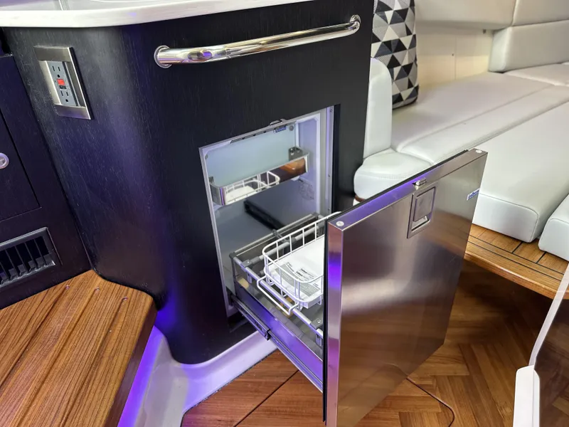 Slide: The Image of Interior of 2025 Boston Whaler 380 Realm featuring a sleek stainless steel drawer fridge. - 22