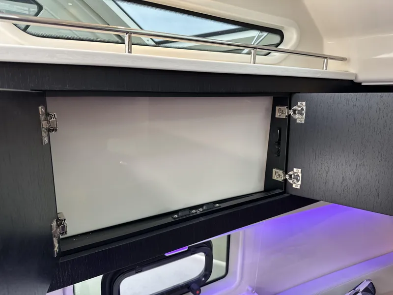 Slide: The Image of Open cabinet inside 2025 Boston Whaler 380 Realm boat, showcasing sleek interior design. - 27